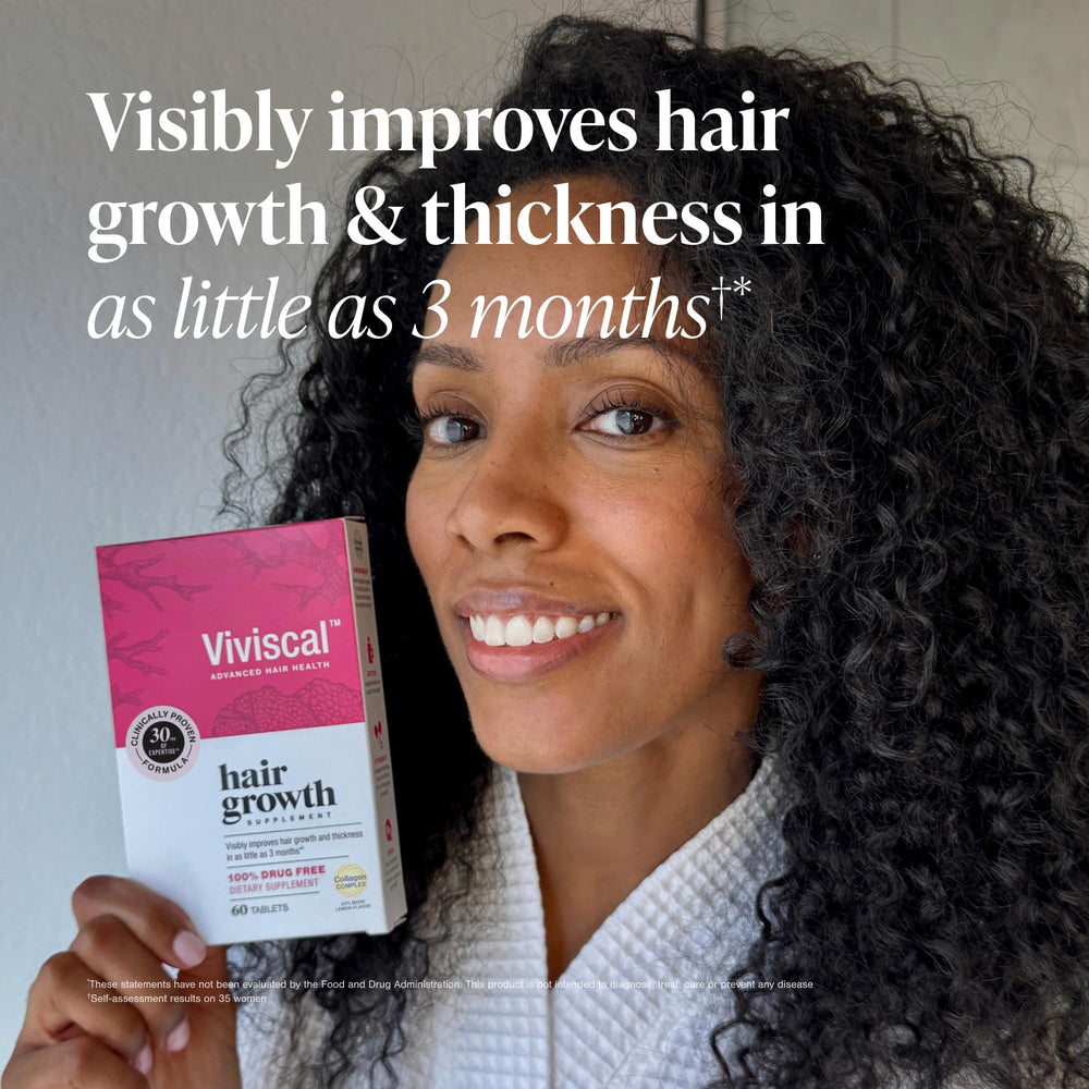 Viviscal tablets in hand suggesting convenient daily use and consistency.
