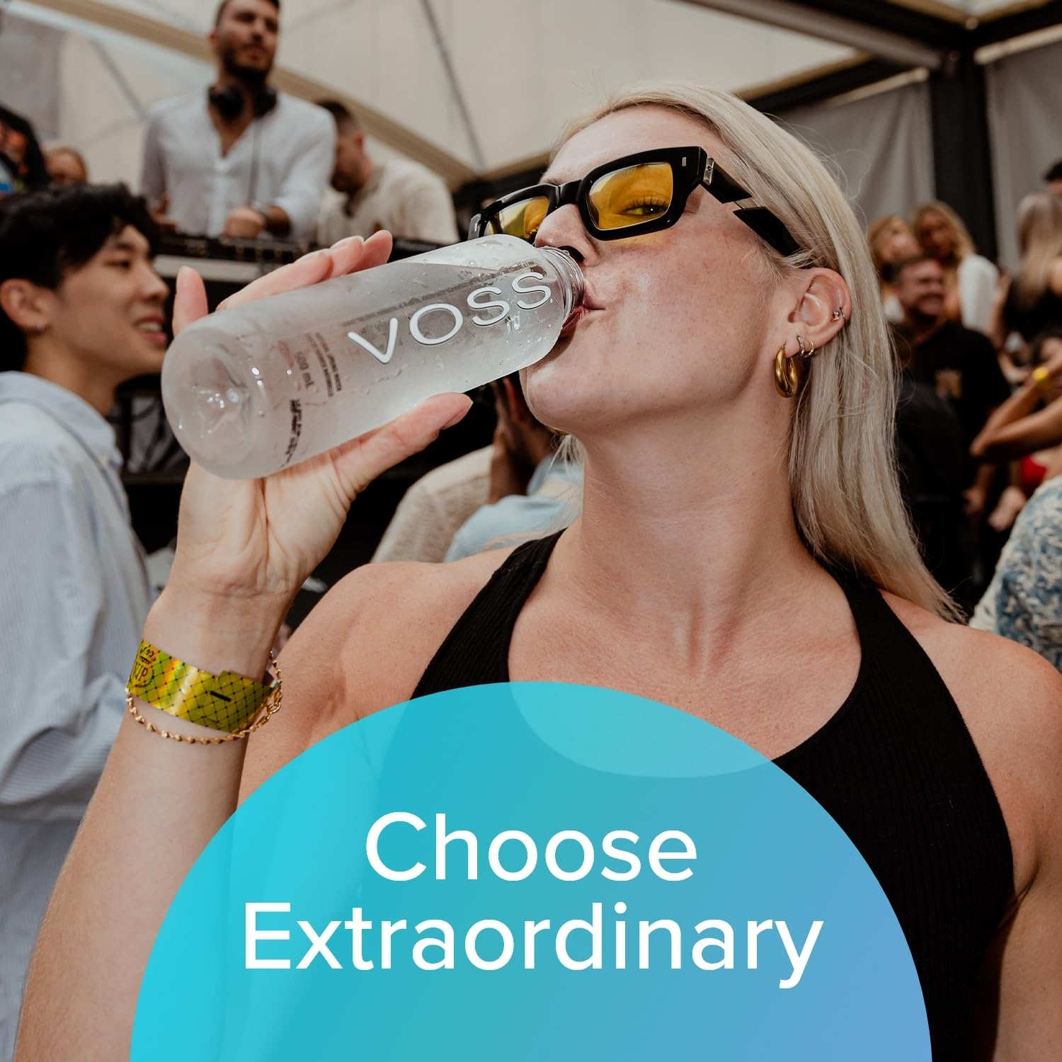 VOSS water bottle at beach or poolside delivering crisp hydration and style.