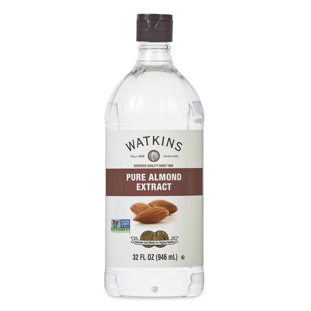 Watkins Pure Almond Extract bottle pouring for baking flavor.