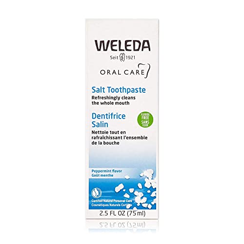 Weleda Natural Salt Toothpaste tubes beside sea salt crystals on packaging for mineral-inspired care.
