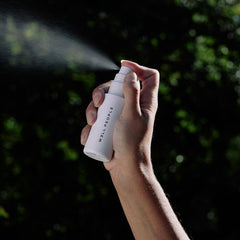 Close-up of mist being used to prime skin for a smooth base