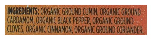 Close-up of Whole Foods Market garam masala label showing organic and non-GMO verification.