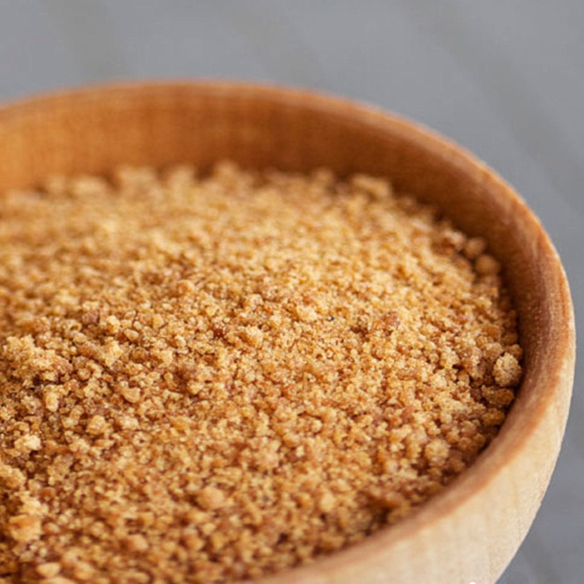 Wholesome Coconut Sugar scoop beside jar for measuring.