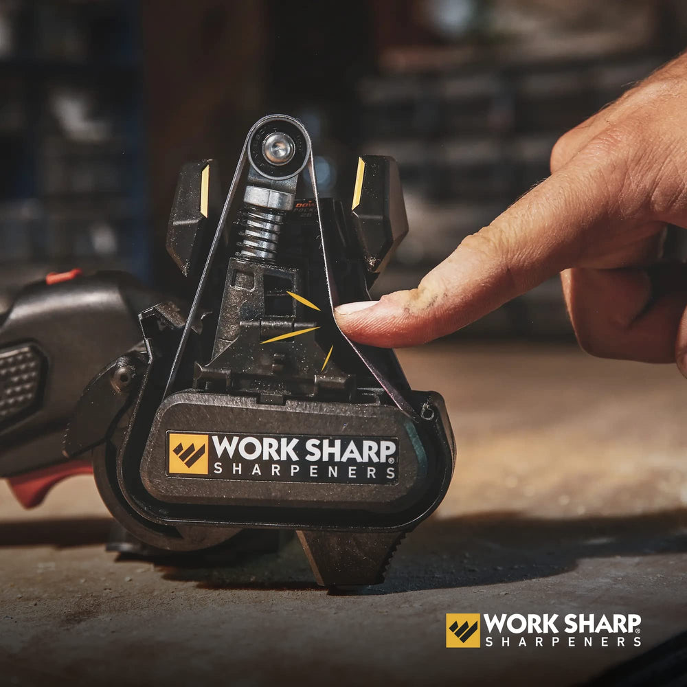 Lawn mower blade being sharpened outdoors with the Mk2
