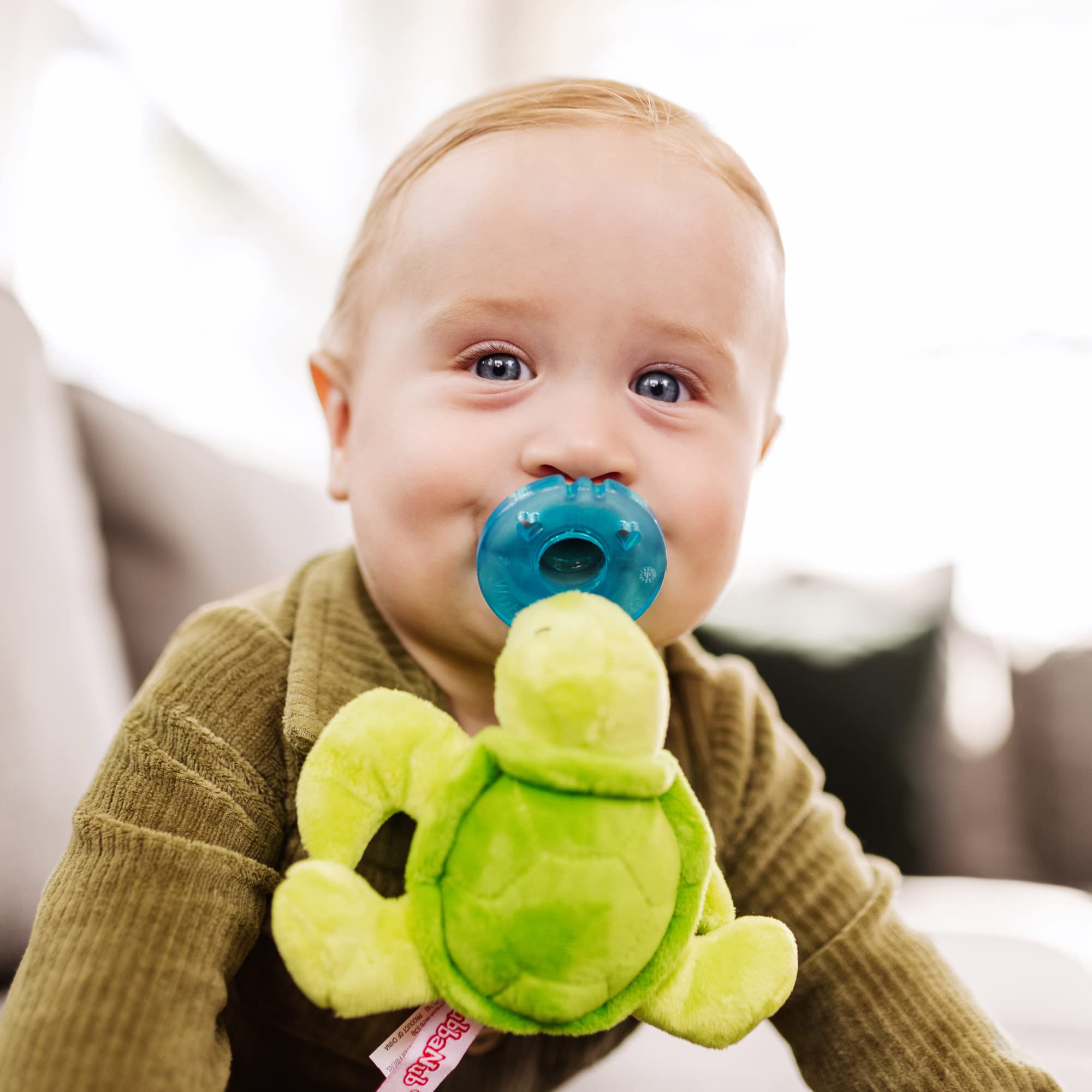 WubbaNub Turtle pacifier plush close-up showing durable one-piece design
