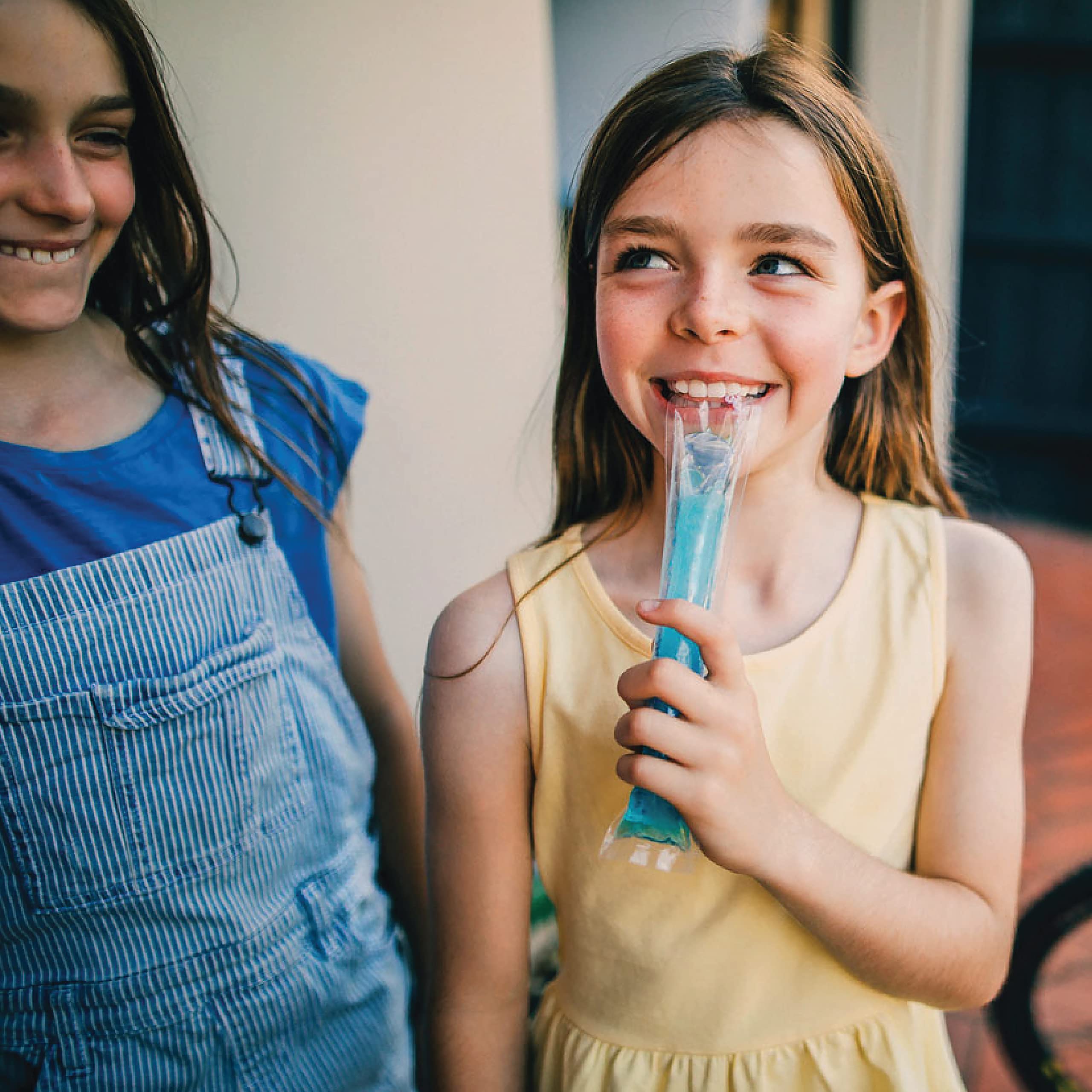 Family enjoying Wyler's Italian Ices on a sunny day.