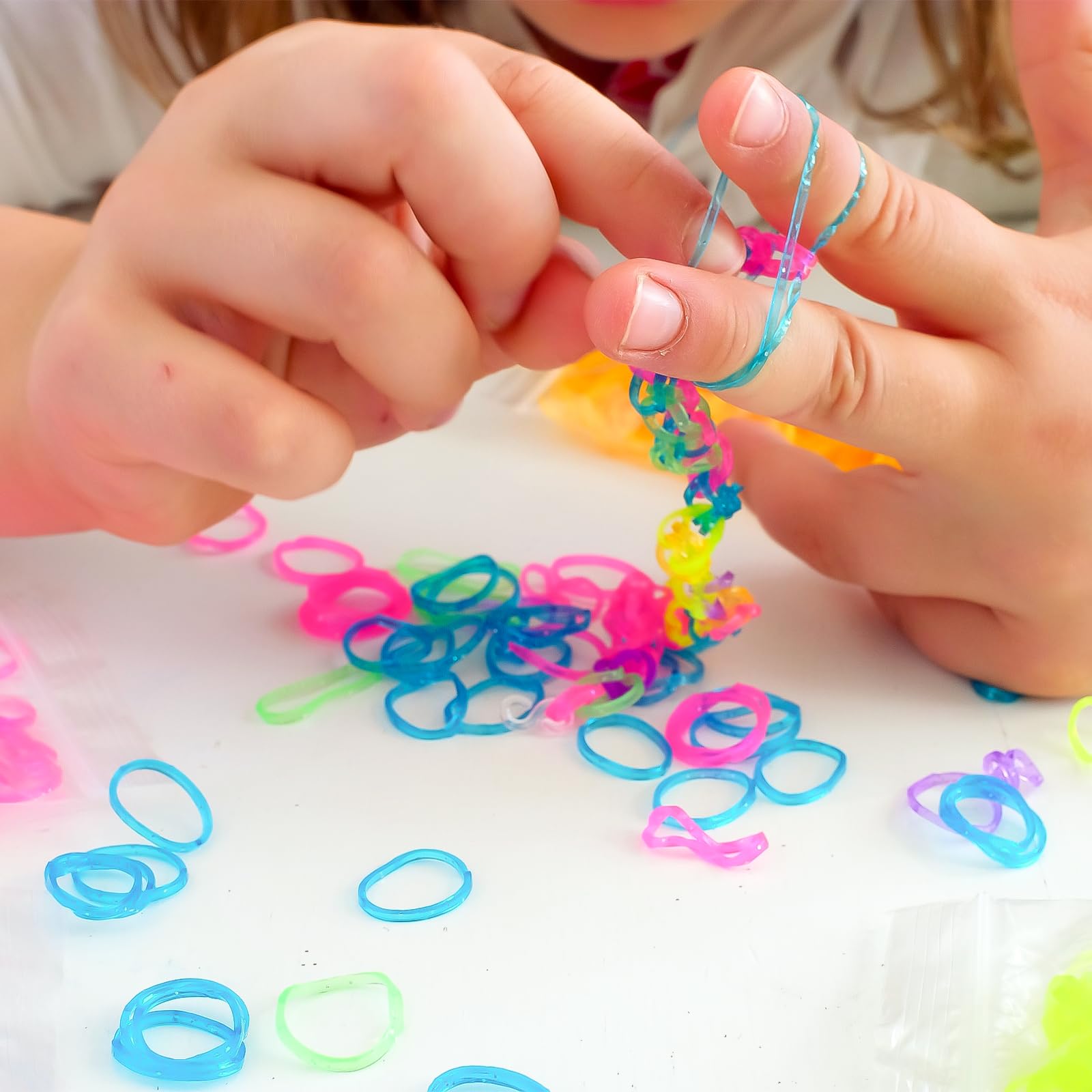 Kids assemble XKDOUS bracelets, enjoying hands-on crafting.