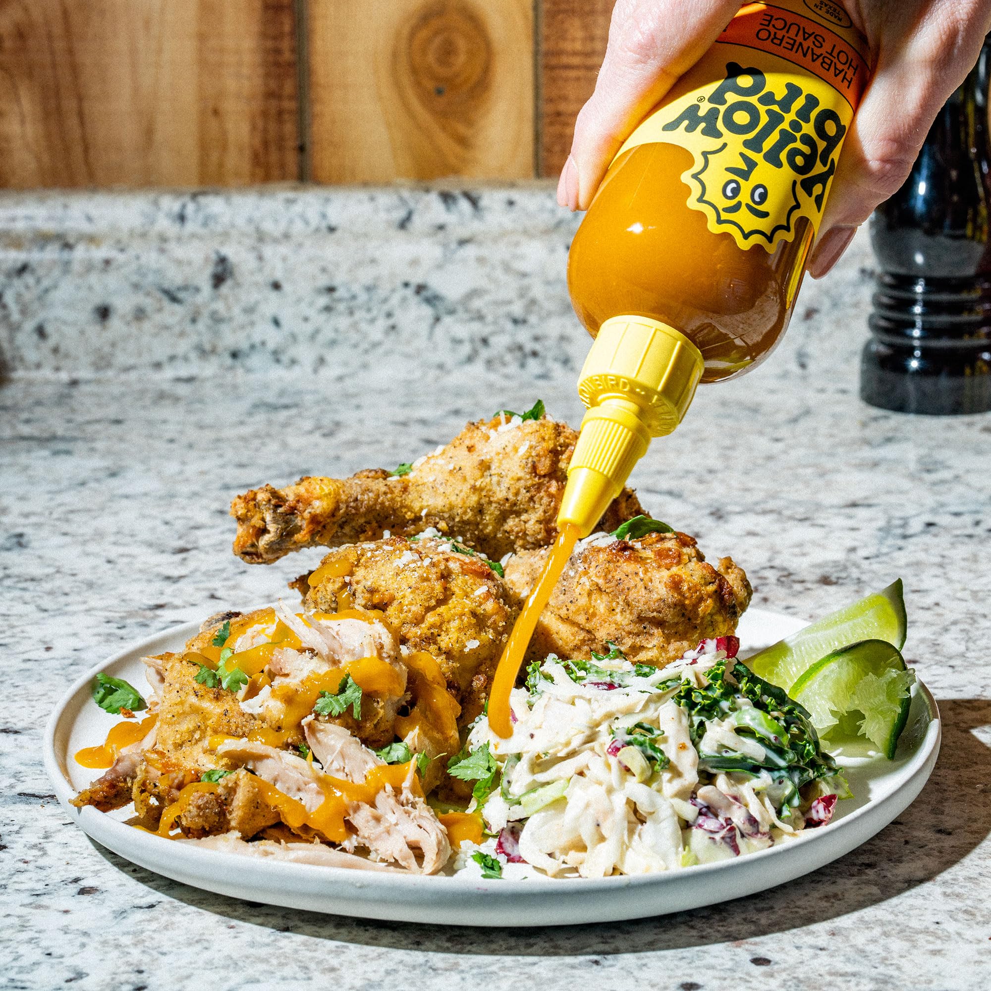 Yellowbird Classic label close-up reveals carrots, garlic, and tangerines for vibrant flavor.