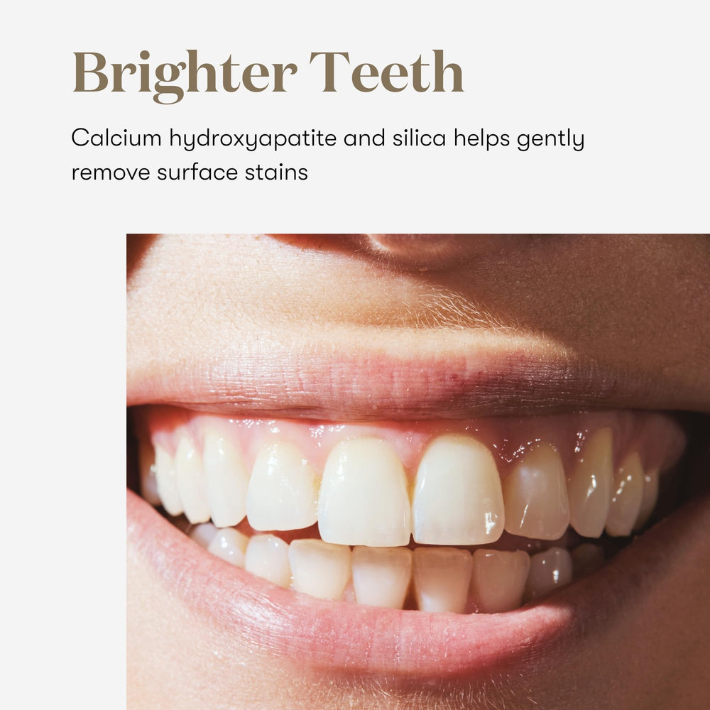 Brushing with Young Living Thieves Whitening Toothpaste for a refreshing mint experience.