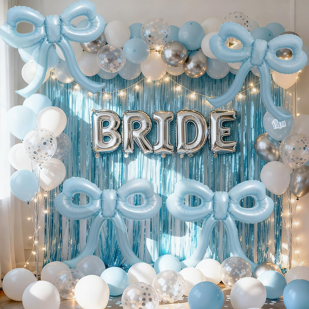 YTHETM blue bow balloon draped from the ceiling for impact.