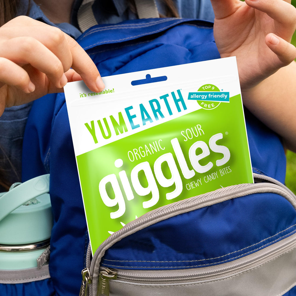 YumEarth Sour Giggles shown with Lemon, Strawberry, Orange, Grape, Green Apple flavors.