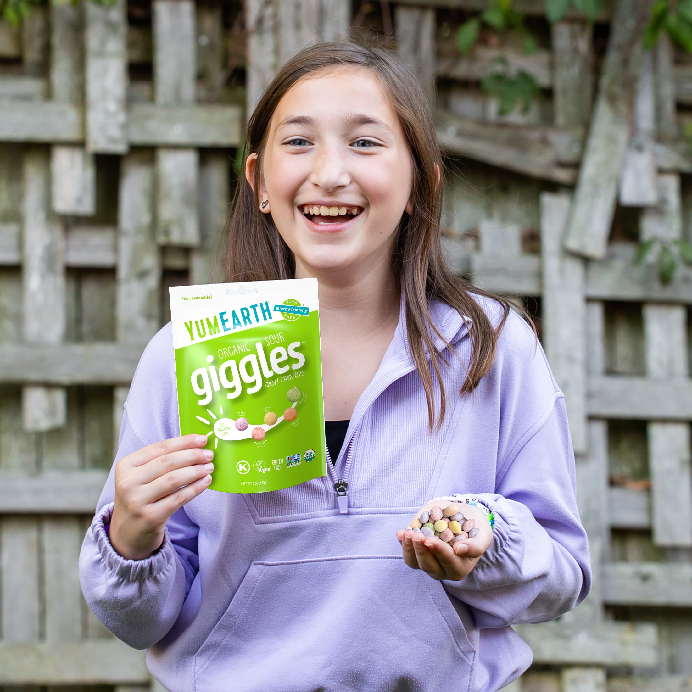Travel-friendly YumEarth Sour Giggles resealable bag in hand
