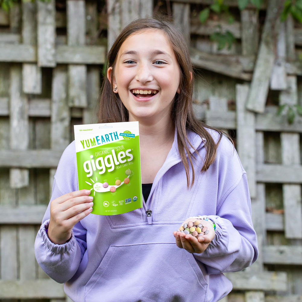 Travel-friendly YumEarth Sour Giggles resealable bag in hand