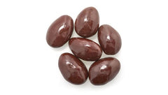 Detail of 60% dark chocolate coating on Yupik almonds, indulgent