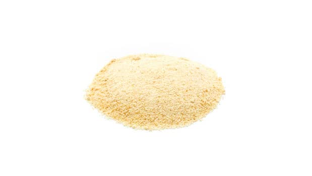 Yupik date powder being measured; convenient for adding to beverages and batters.