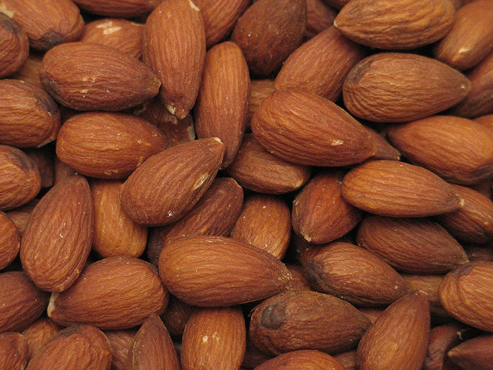 Yupik dry roasted almonds close-up of golden toasted nuts.