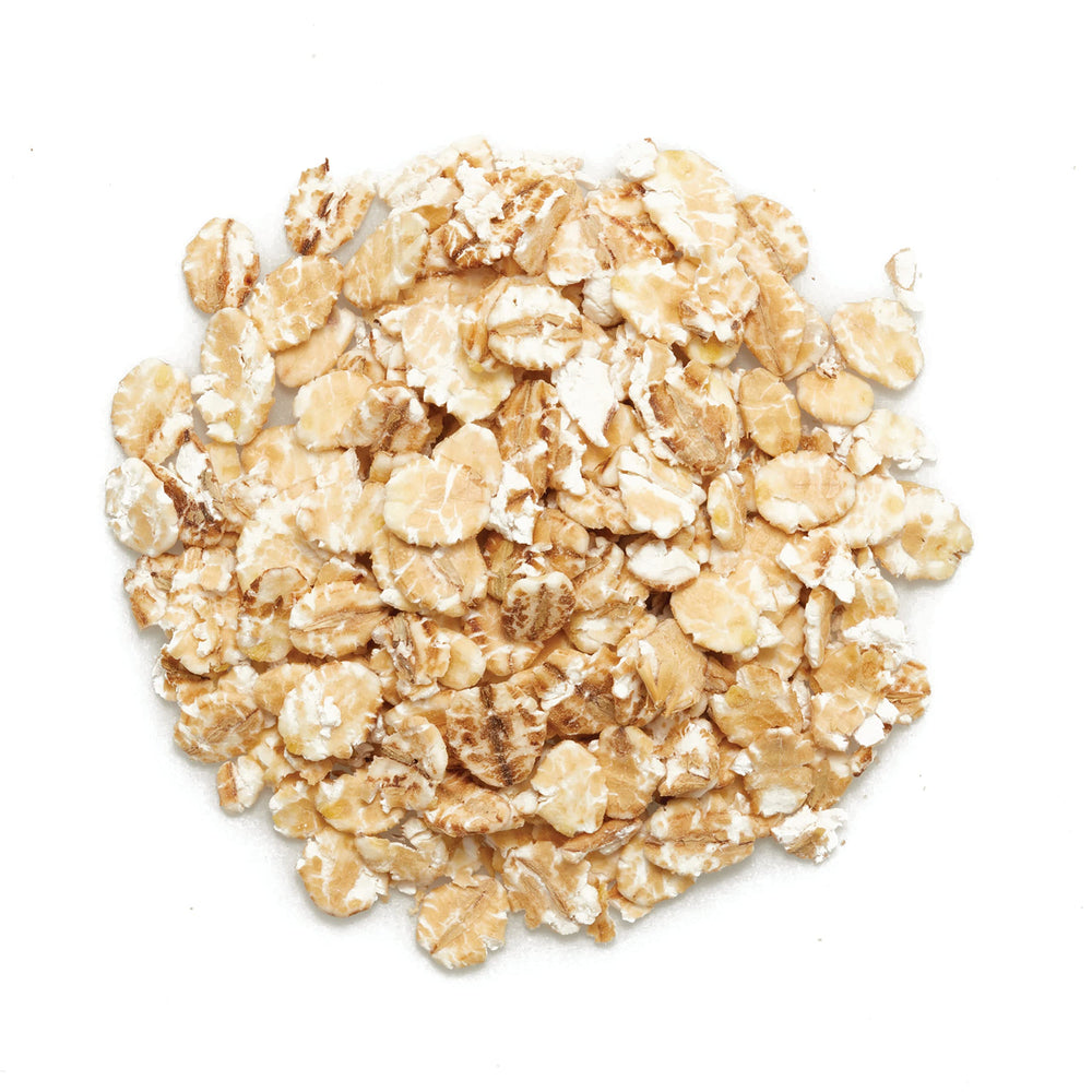 Measuring cup with barley flakes, ideal for precise cooking.