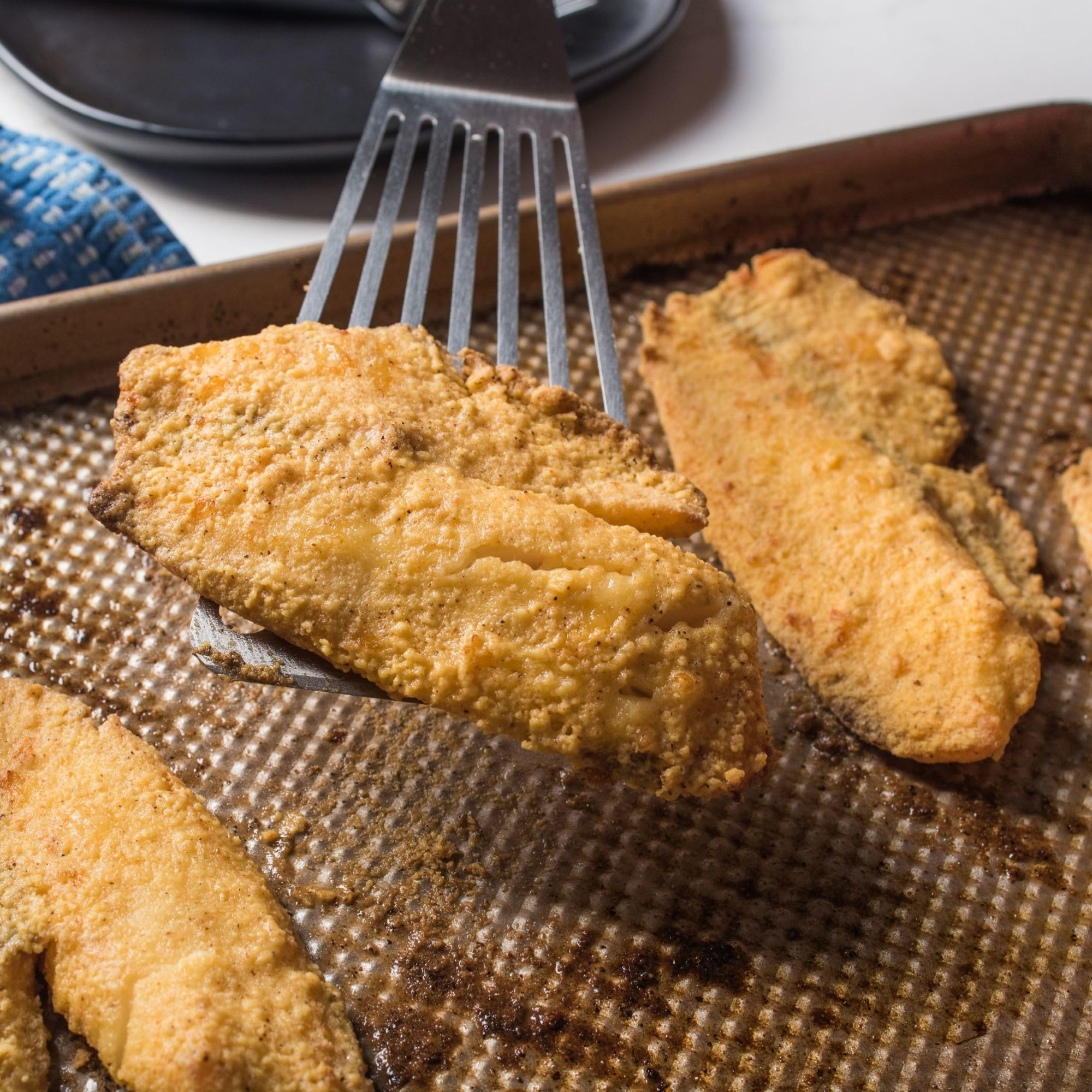 Fish coated with Zatarain's Fish Fri ready for pan frying with even browning.