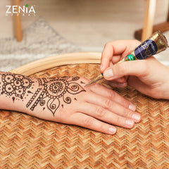 Zenia freckles design with reddish-brown paste on skin